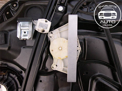 Car door interior showing a window regulator mechanism.