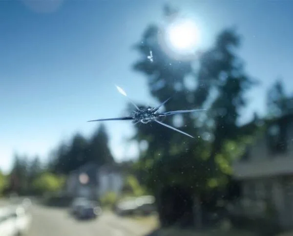 Cracked windshield with a star-shaped impact point