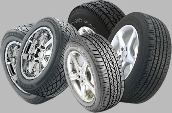Set of four car tires with alloy wheels.