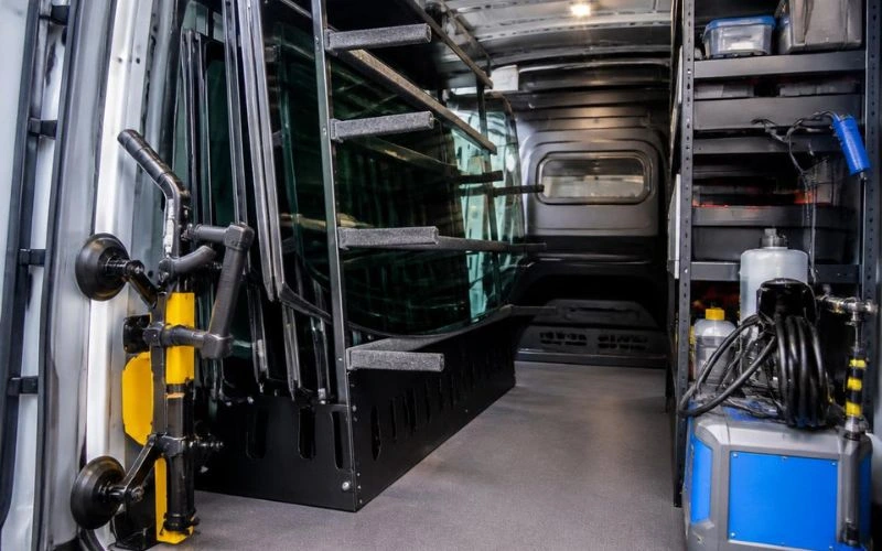 Interior of a mobile auto glass repair van stocked with glass and equipment in Charlotte