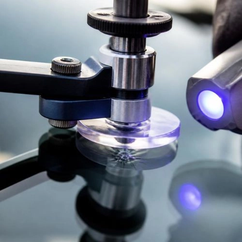 Precision resin repair tool curing chipped windshield glass in Charlotte
